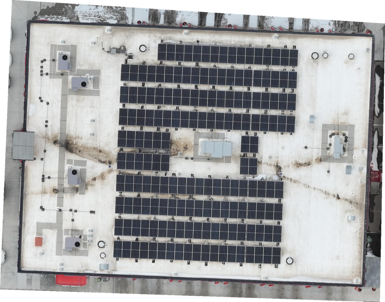 Aerial RGB view of commercial rooftop solar panel installation